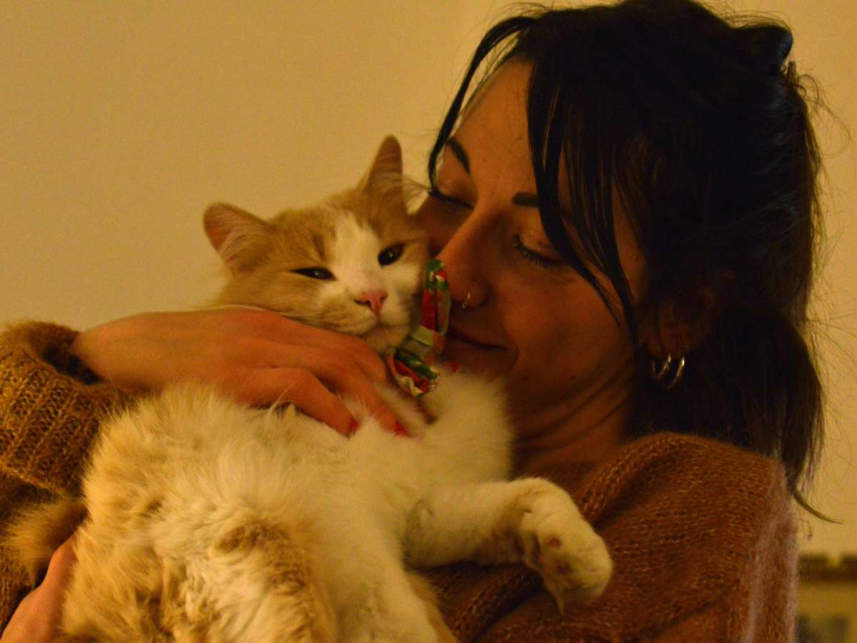 Happy woman snuggling with cat